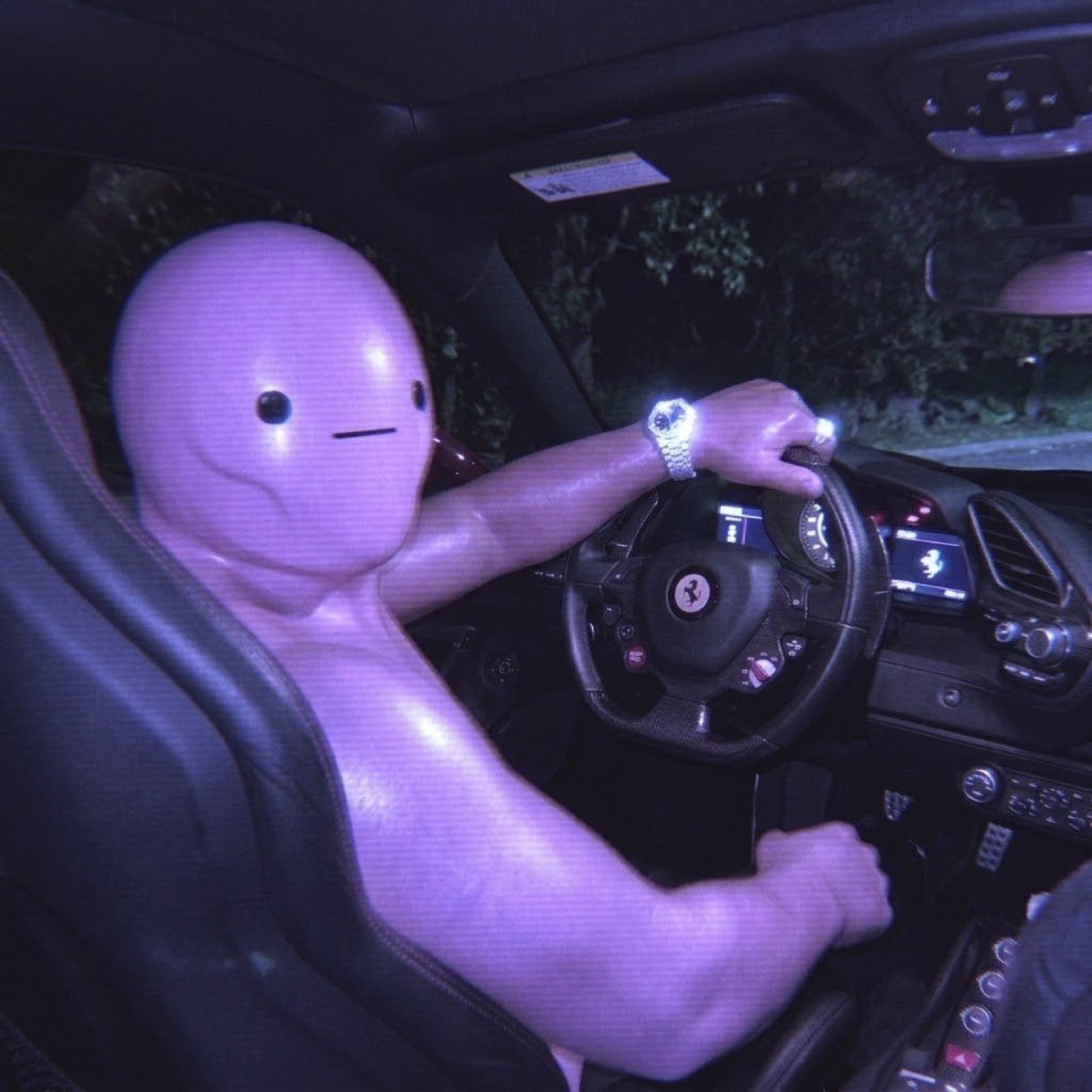 HIM behind the wheel of a Ferrari at night
